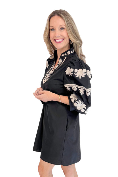 Side view of woman in Black With Cream Embroidery Puff Sleeve Dress by Entro. 