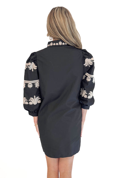 Back view of woman in Black With Cream Embroidery Puff Sleeve Dress by Entro. 