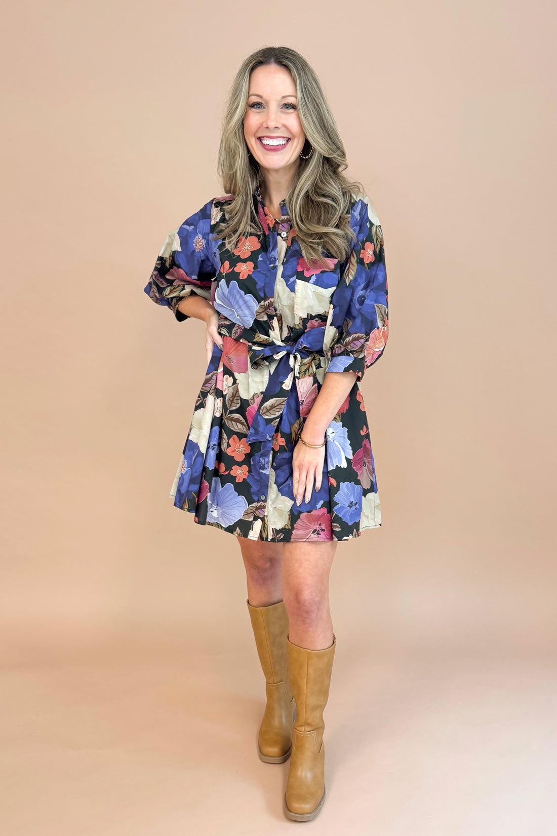 Woman in Black button-up mini dress with colorful floral print, featuring puff sleeves and self-tie waist by Entro