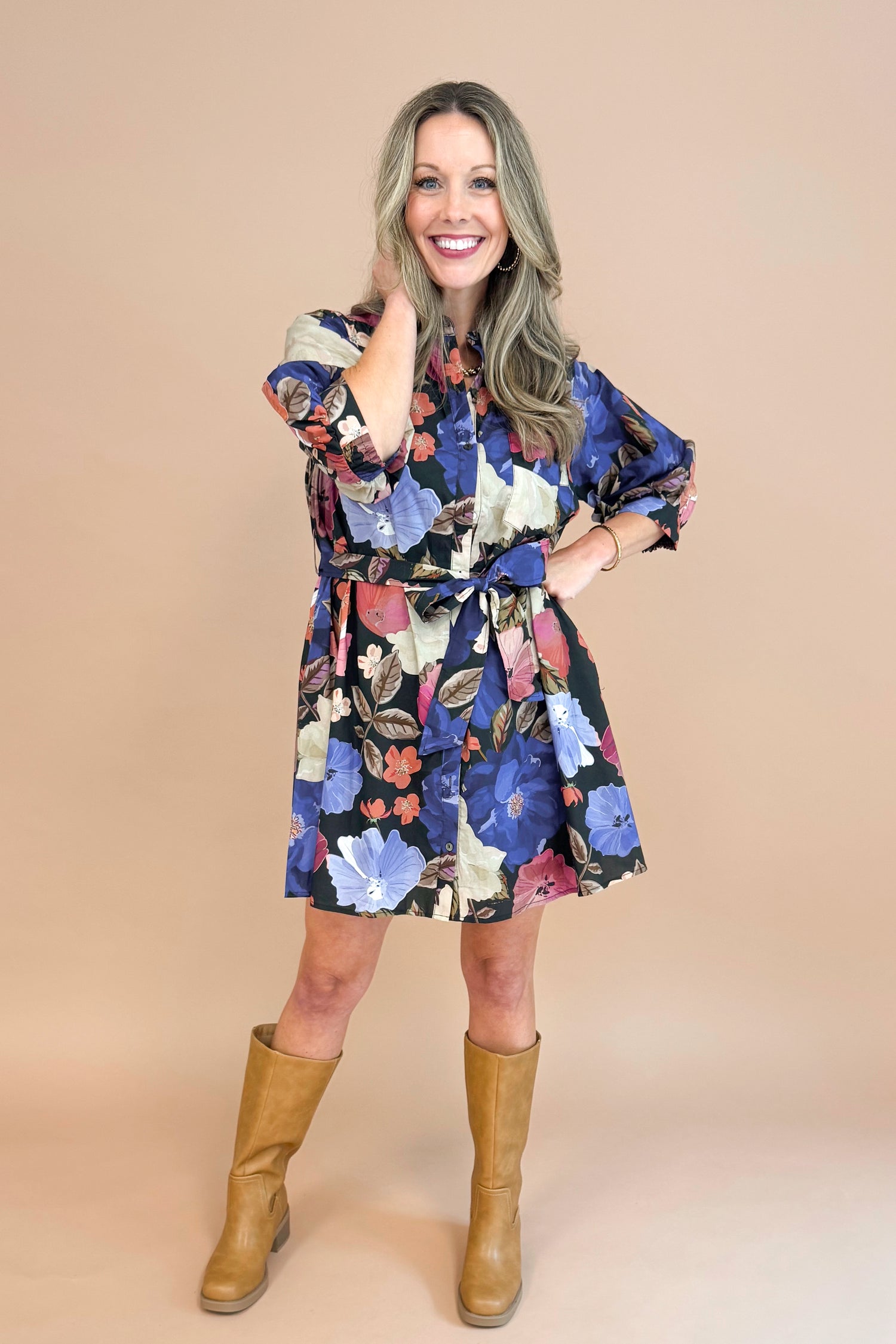 Woman in Black button-up mini dress with colorful floral print, featuring puff sleeves and self-tie waist by Entro