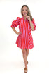 Front view of woman wearing Pink & Red Striped Tie Back Dress by Entro with sandals against white studio background.