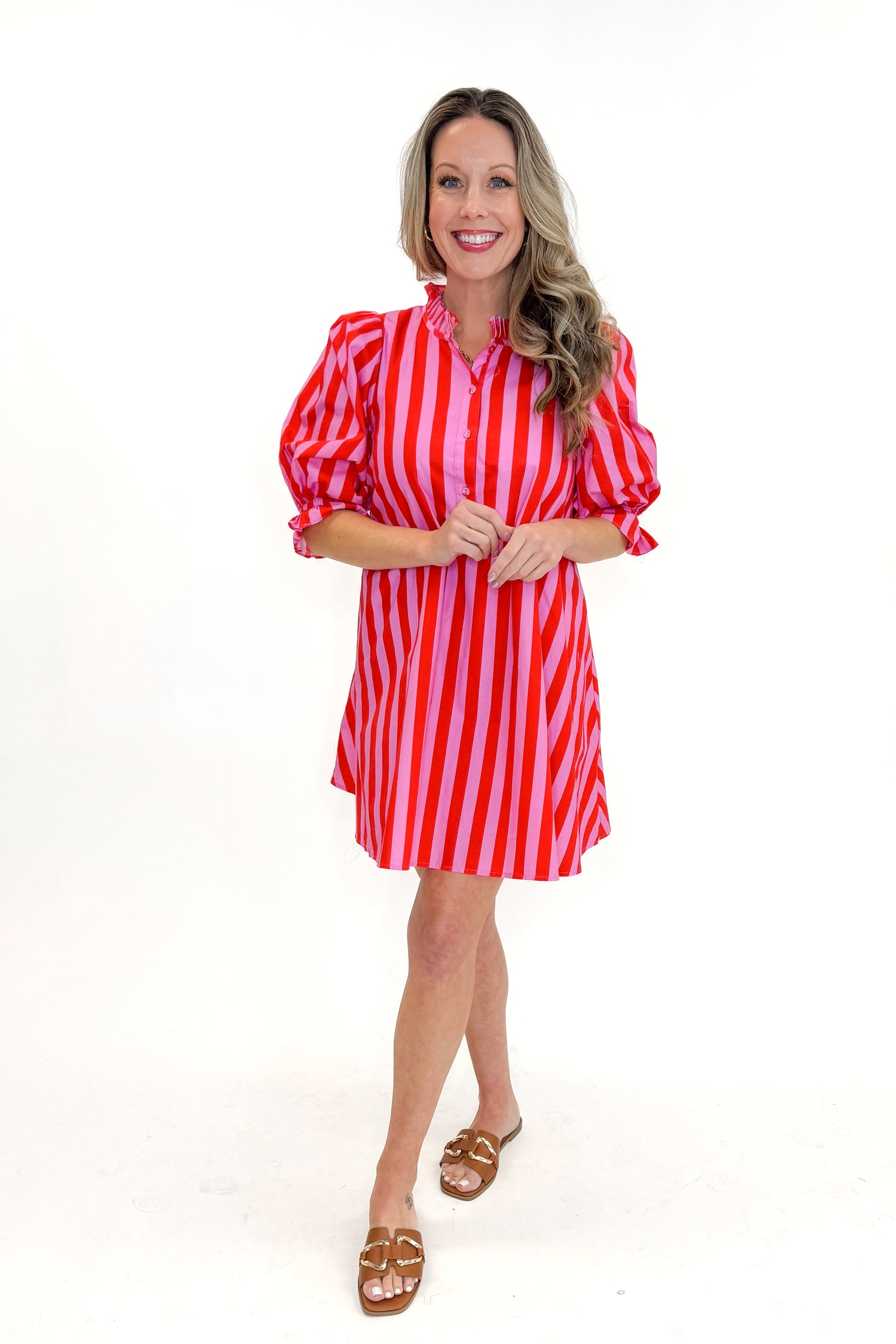 Front view of woman wearing Pink &amp; Red Striped Tie Back Dress by Entro with sandals against white studio background.