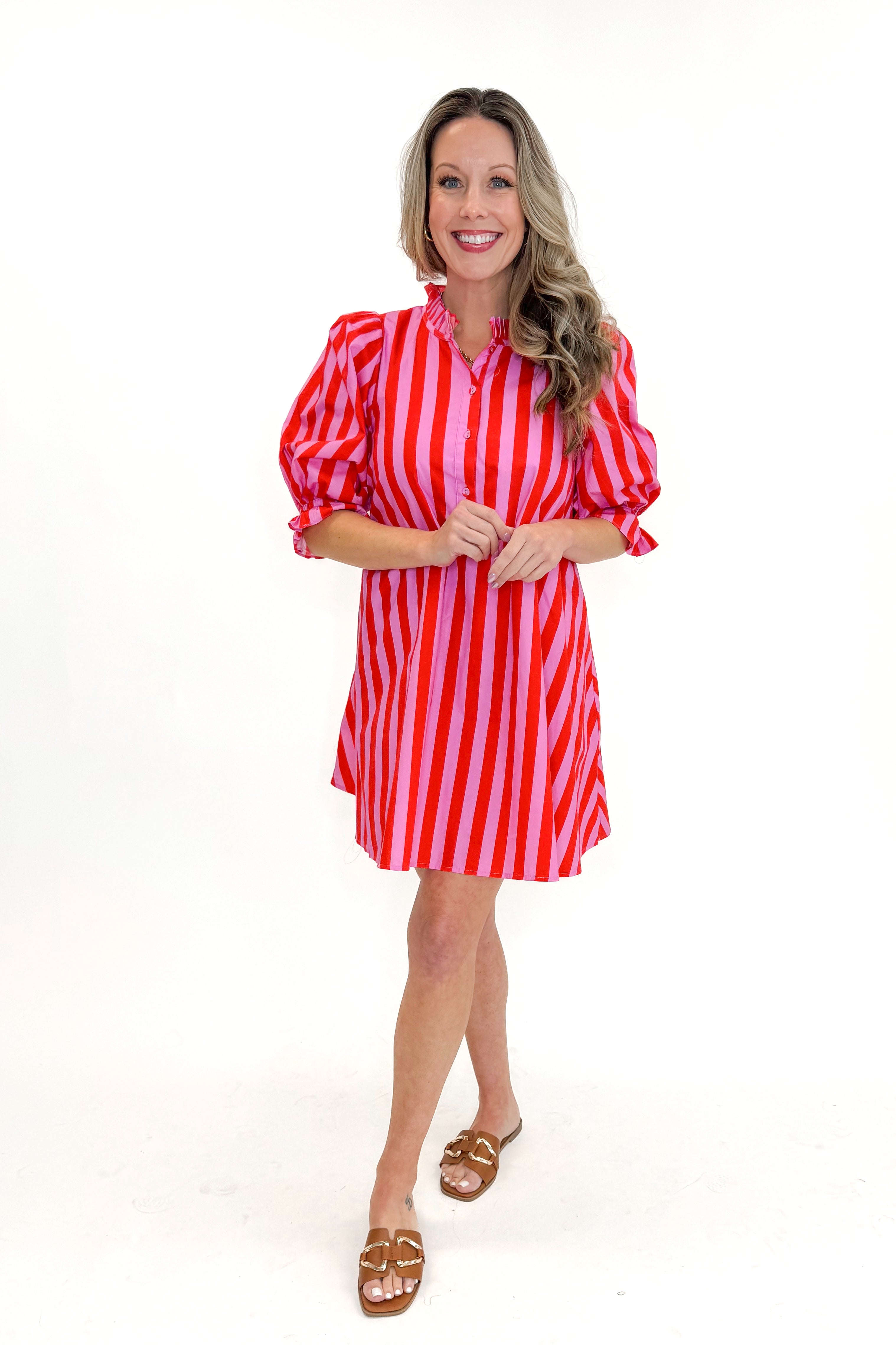 Front view of woman wearing Pink &amp; Red Striped Tie Back Dress by Entro with sandals against white studio background.