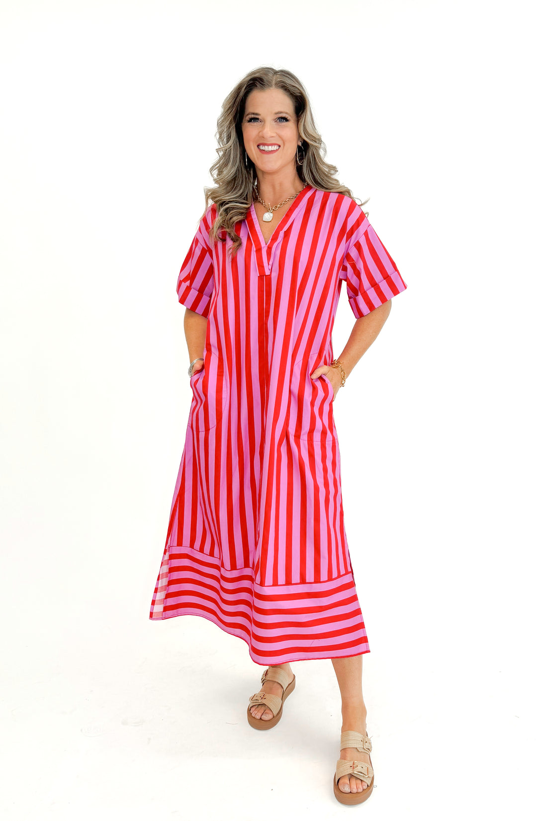Front view of woman wearing Pink &amp; Red Two Toned Striped Midi Dress by Entro  against white studio background.