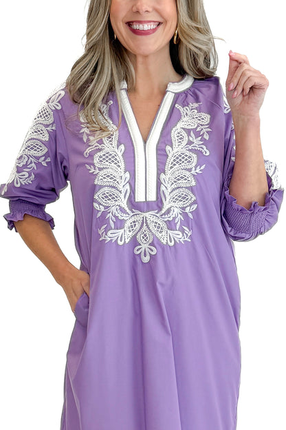 Front detail view of woman wearing Lavender Embroidered V-Neck Half Sleeve Midi Dress by Entro against white studio background.