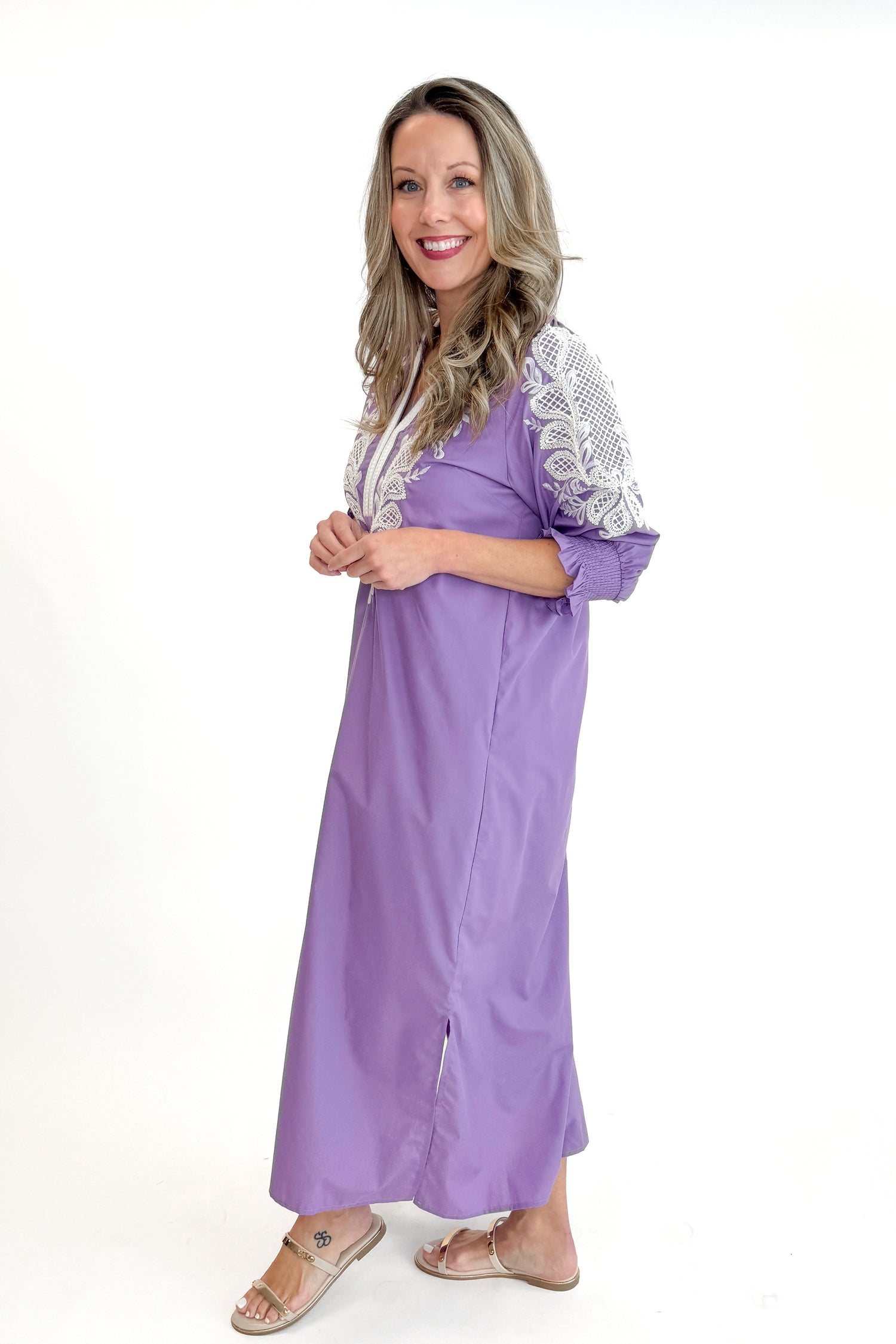 Side view of woman wearing Lavender Embroidered V-Neck Half Sleeve Midi Dress by Entro against white studio background.
