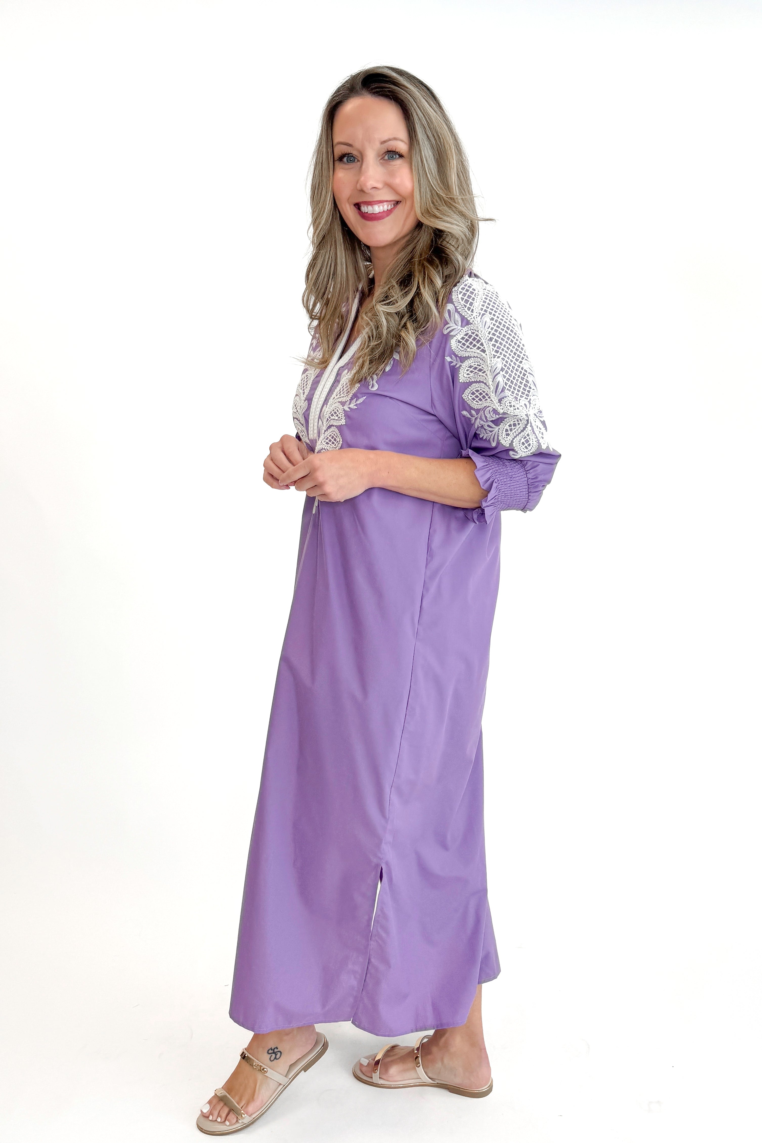 Side view of woman wearing Lavender Embroidered V-Neck Half Sleeve Midi Dress by Entro against white studio background.
