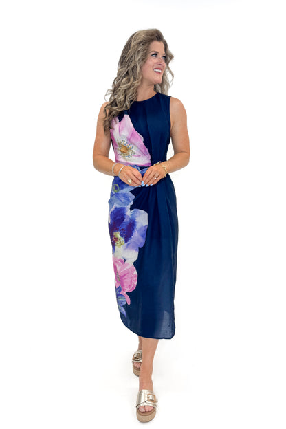 Front view of woman wearing Navy Floral Pleat Detail Midi Dress by Entro against white studio background.