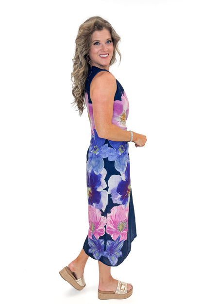 Side view of woman wearing Navy Floral Pleat Detail Midi Dress by Entro against white studio background.