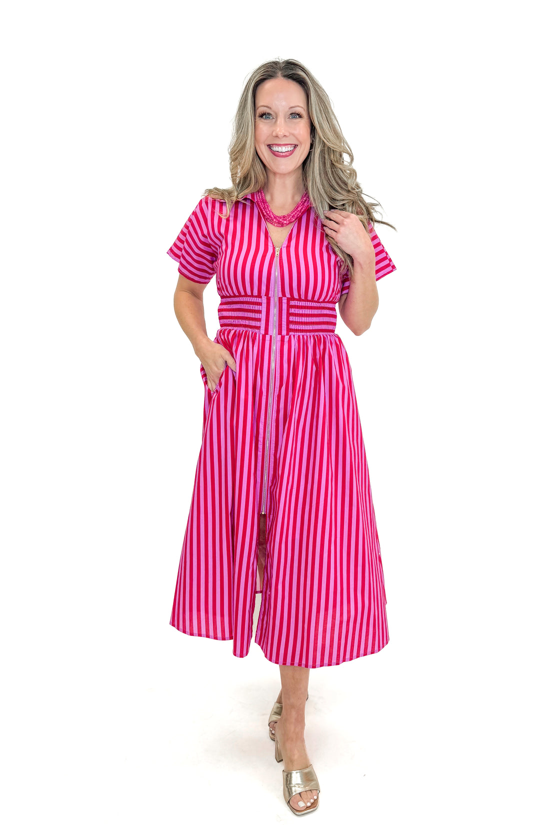 Front view of woman wearing Red &amp; Pink Striped Center Zip Midi Dress by Entro against white studio background.