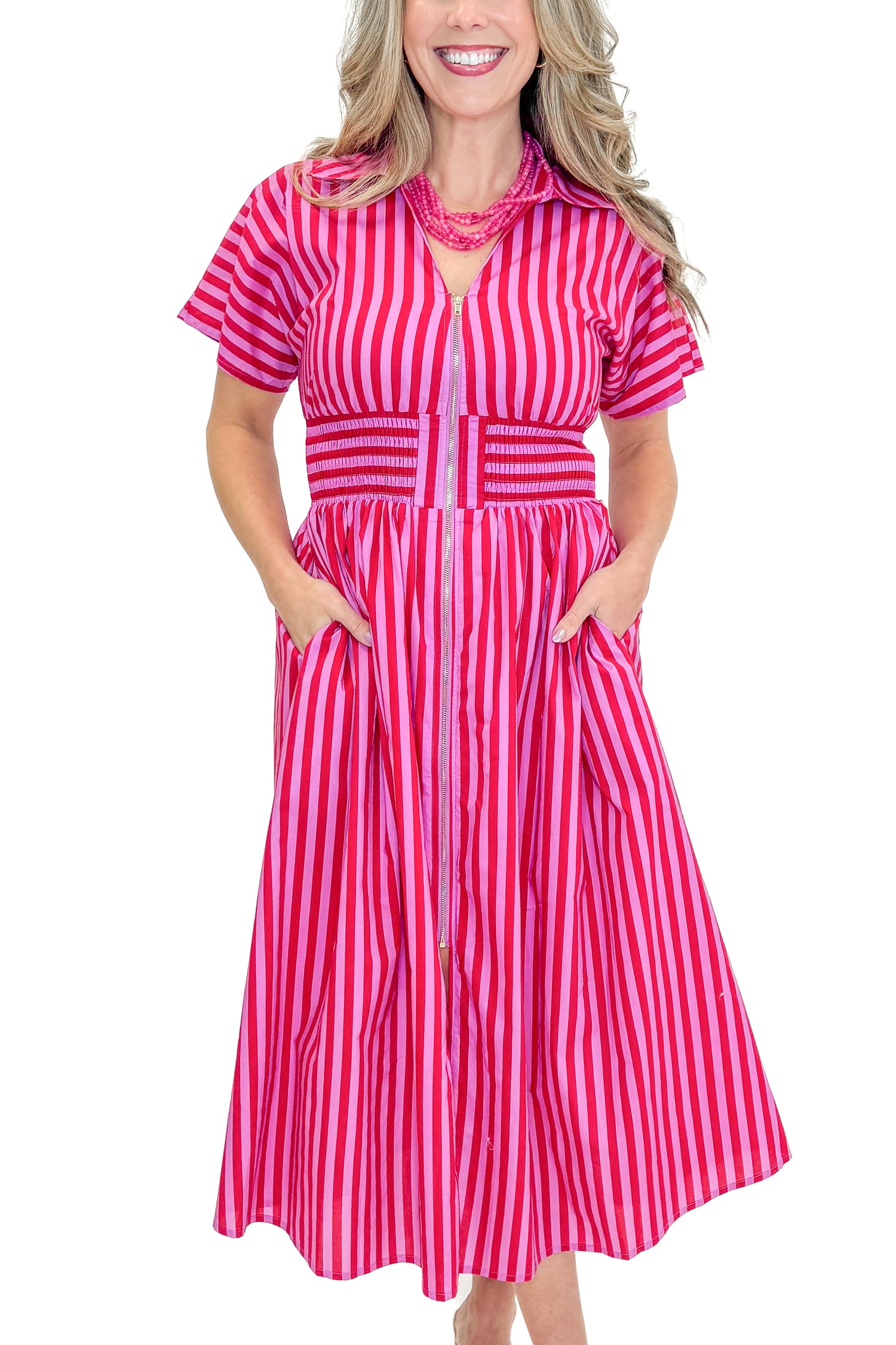 Front view of woman wearing Red &amp; Pink Striped Center Zip Midi Dress by Entro against white studio background.