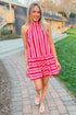 Front view of woman wearing Pink & Red Striped Halter Neck Dress by Entro outside walking.