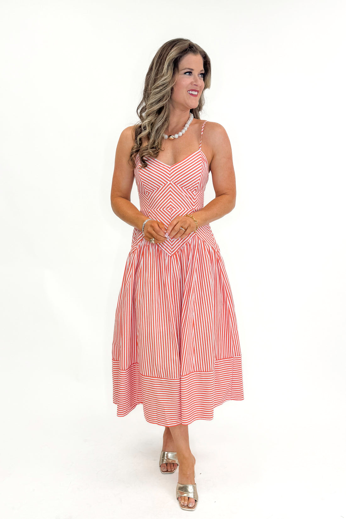 Front view of woman wearing Orange Stripe &amp; V Detail Midi Dress by Entro  against white studio background.