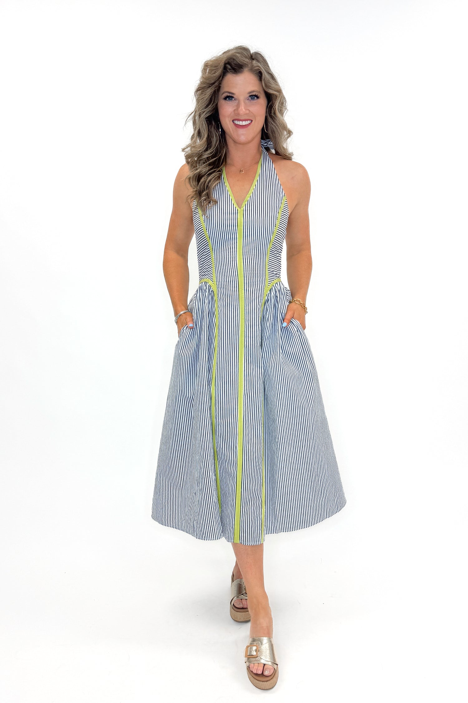 Front view of woman wearing Navy With Green Stripe Detail Halter Midi Dress by Entro with sandals against white studio background.