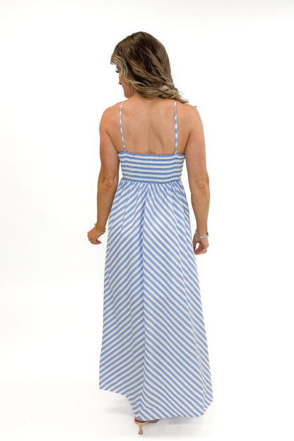 Back view of woman wearing Blue Striped Embroidered Halter Neck Maxi Dress by Entro against white studio background.
