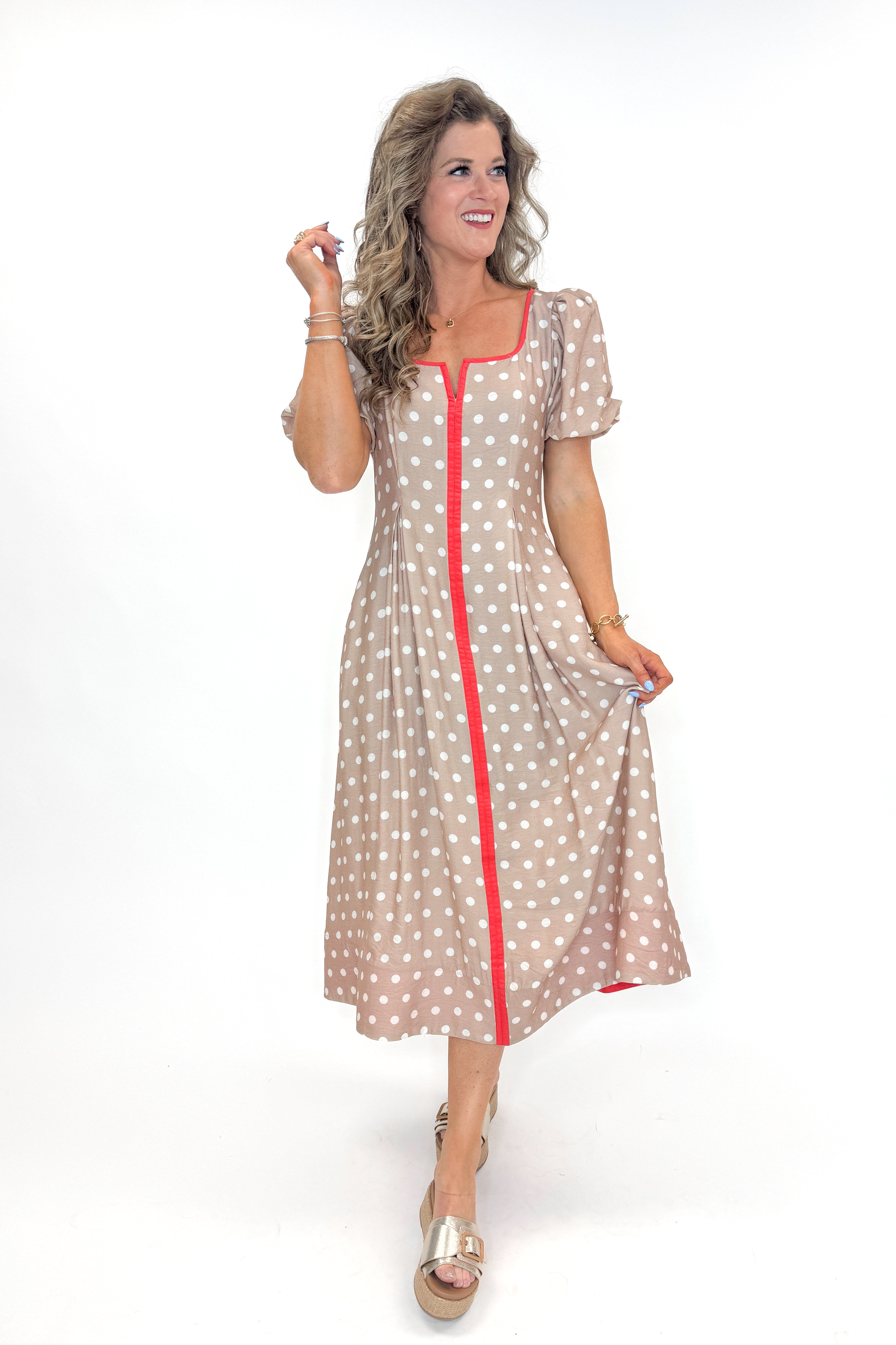 Front view of woman wearing Sand With Red Stripe Detail Polka Dot Midi Dress by Entro against white studio background.