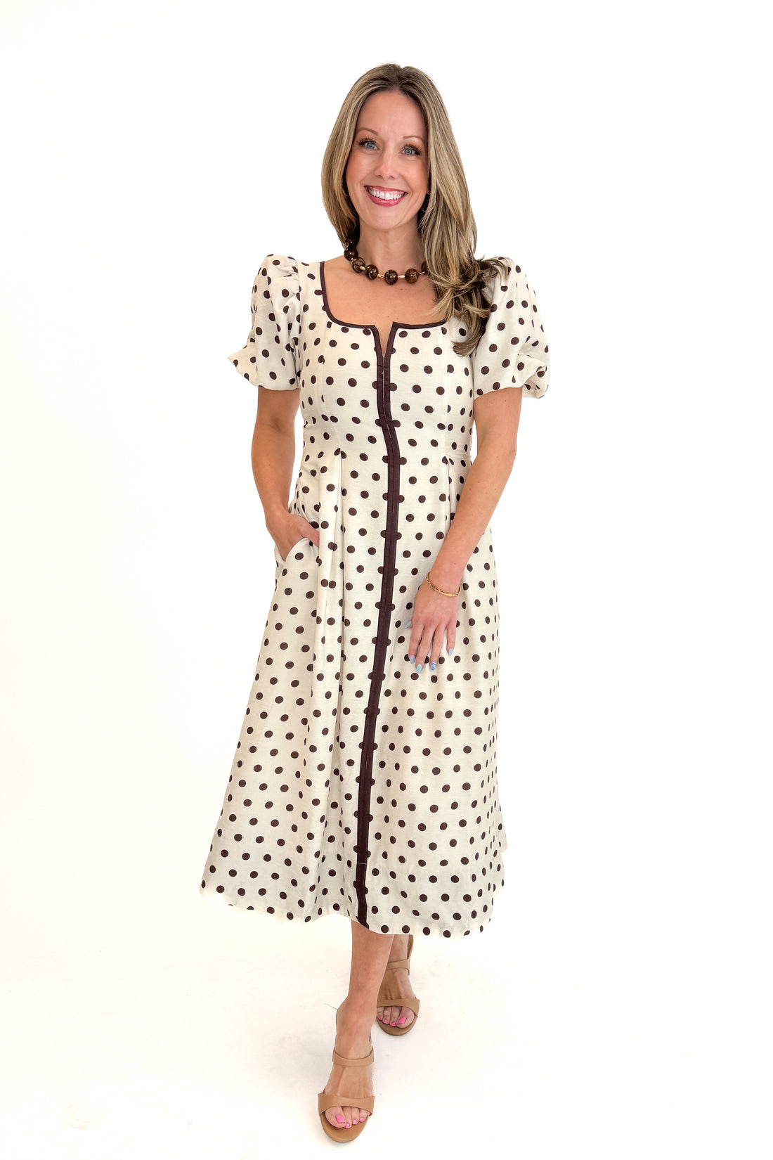 Front view of woman wearing Cream With Brown Stripe Detail Polka Dot Midi Dress by Entro against white studio background.