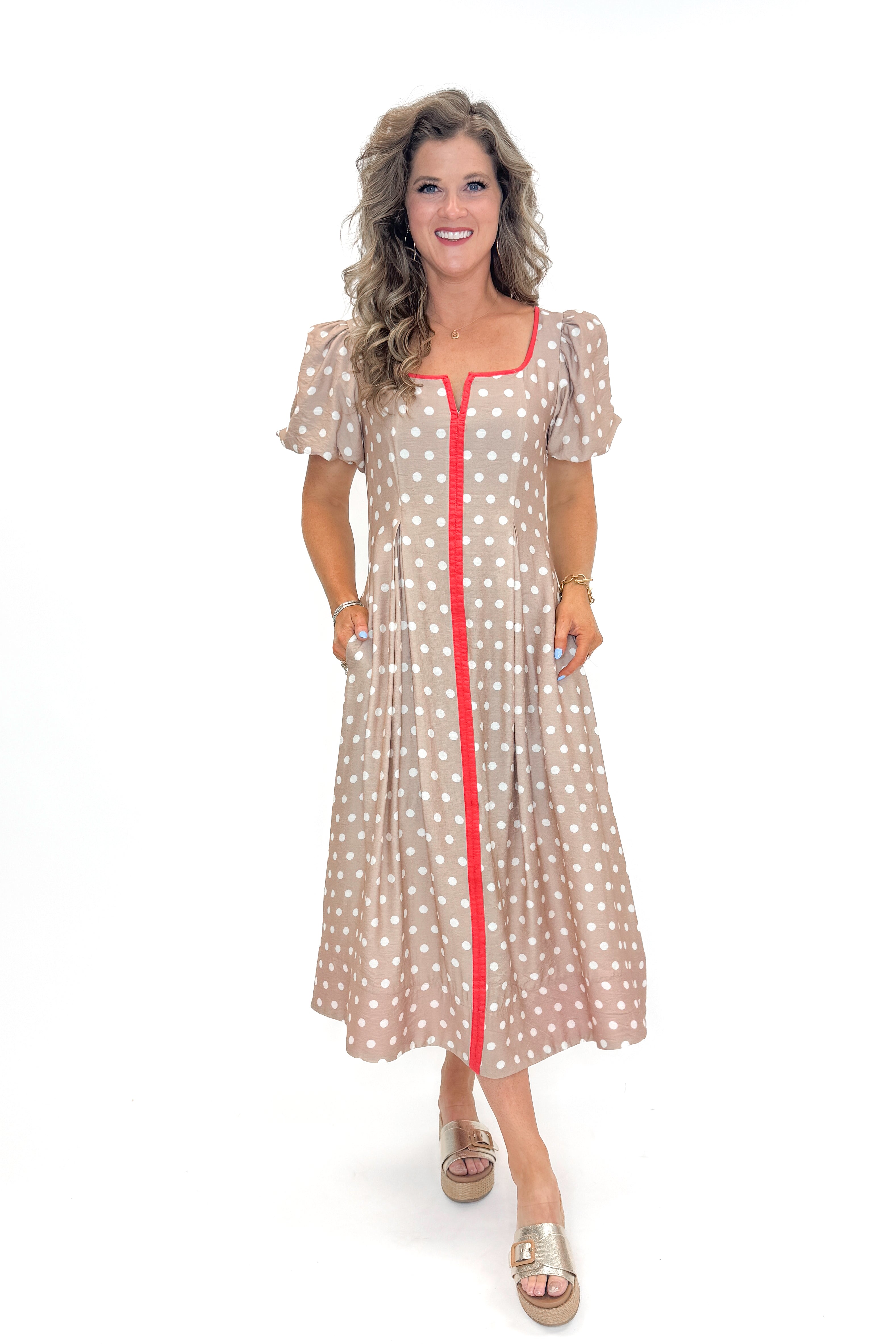 Front view of woman wearing Sand With Red Stripe Detail Polka Dot Midi Dress by Entro against white studio background.