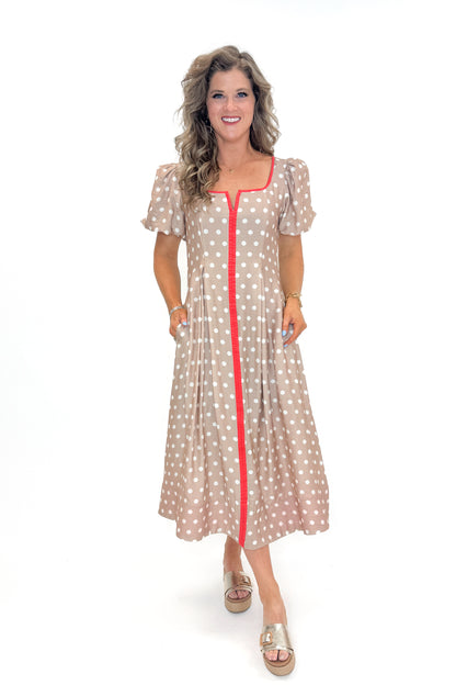 Front view of woman wearing Sand With Red Stripe Detail Polka Dot Midi Dress by Entro against white studio background.
