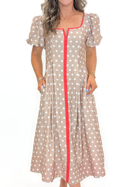 Front detail view of woman wearing Sand With Red Stripe Detail Polka Dot Midi Dress by Entro against white studio background.