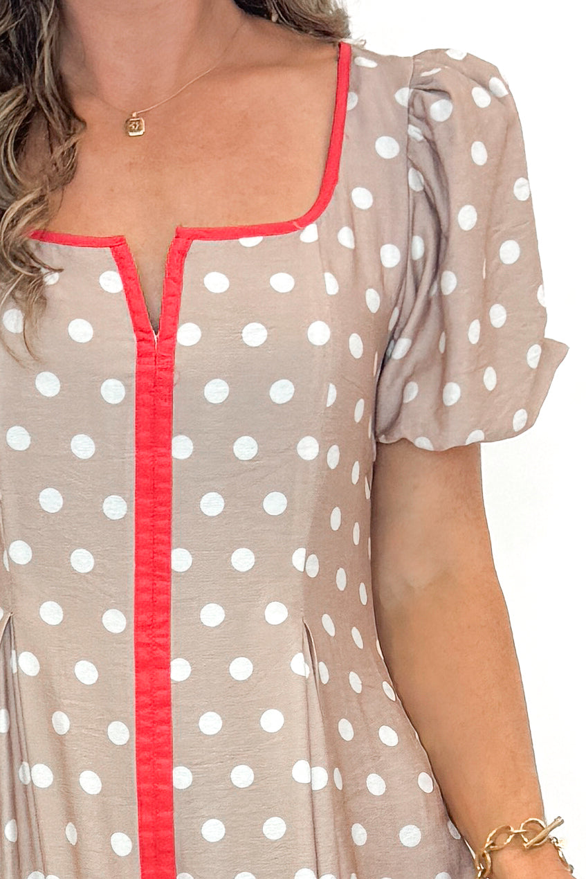 Front detail view of woman wearing Sand With Red Stripe Detail Polka Dot Midi Dress by Entro against white studio background.