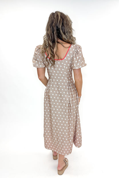 Back view of woman wearing Sand With Red Stripe Detail Polka Dot Midi Dress by Entro against white studio background.