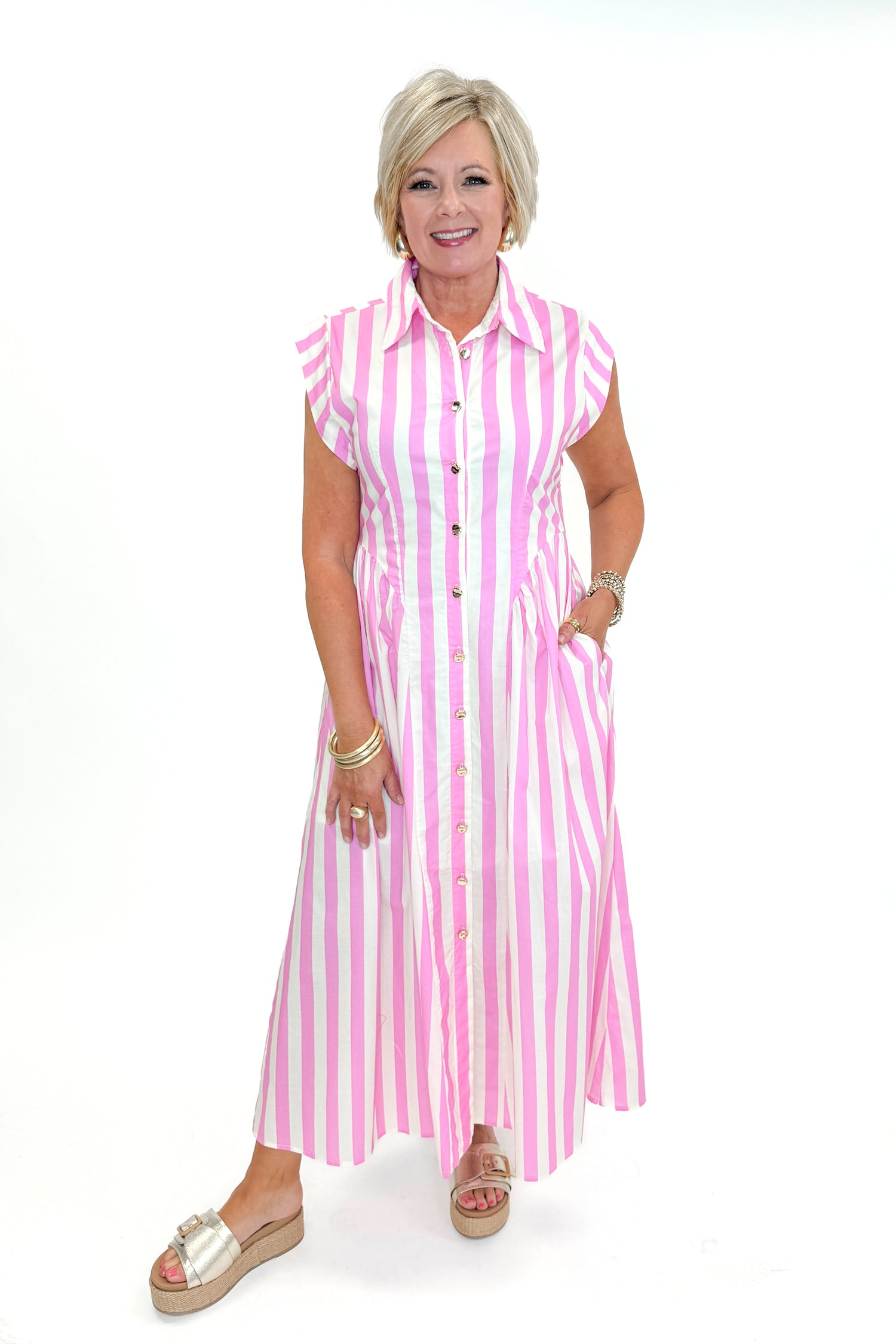 Front view of woman wearing Pink Striped Button Down Midi Dress by Entro with sandals against white studio background.