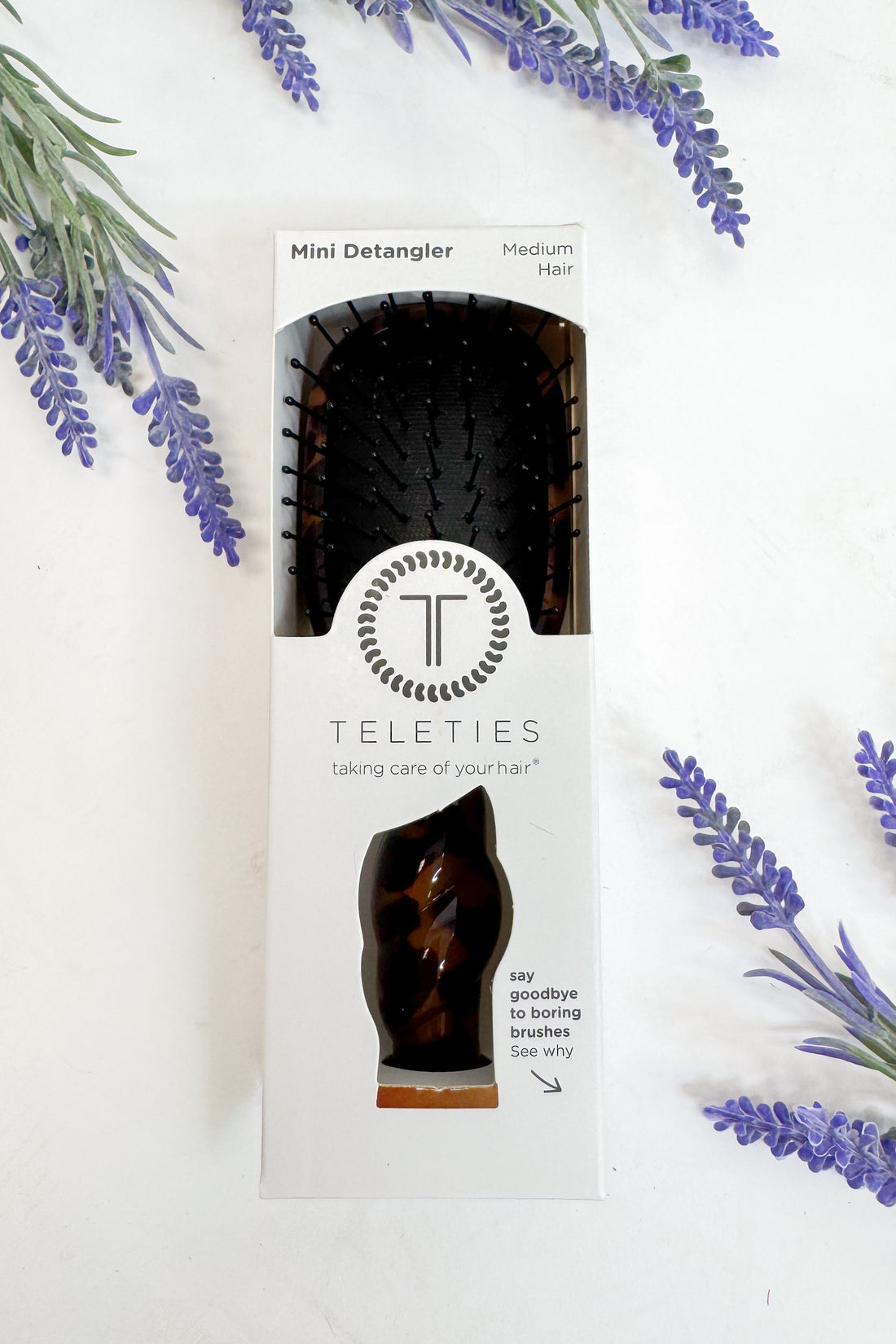 Teleties mini detangler packaging with lavender leaves on a white background