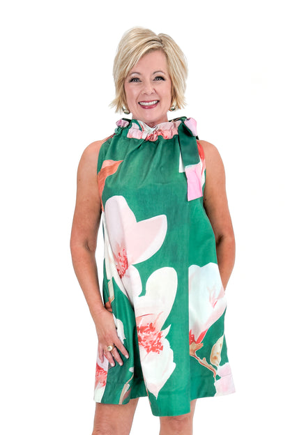 Front view of woman wearing Green Floral Tie Neck Mini Dress against white studio background.