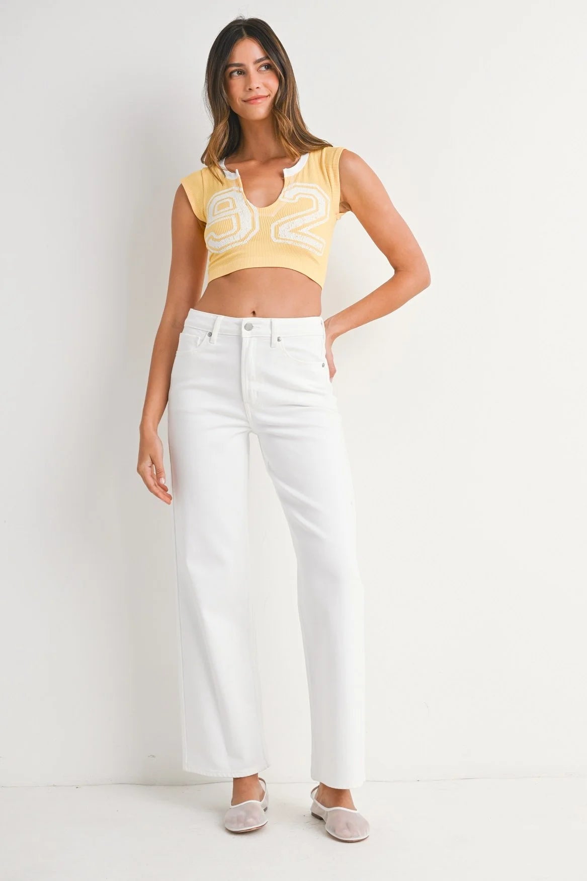 Stock photo with front view of model wearing White Straight Leg Jeans by Just Black Denim against white studio background.