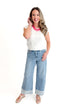 Front view of woman wearing Light Wash Two Toned Jeans by Just Black Denim with white sweater against white studio background.