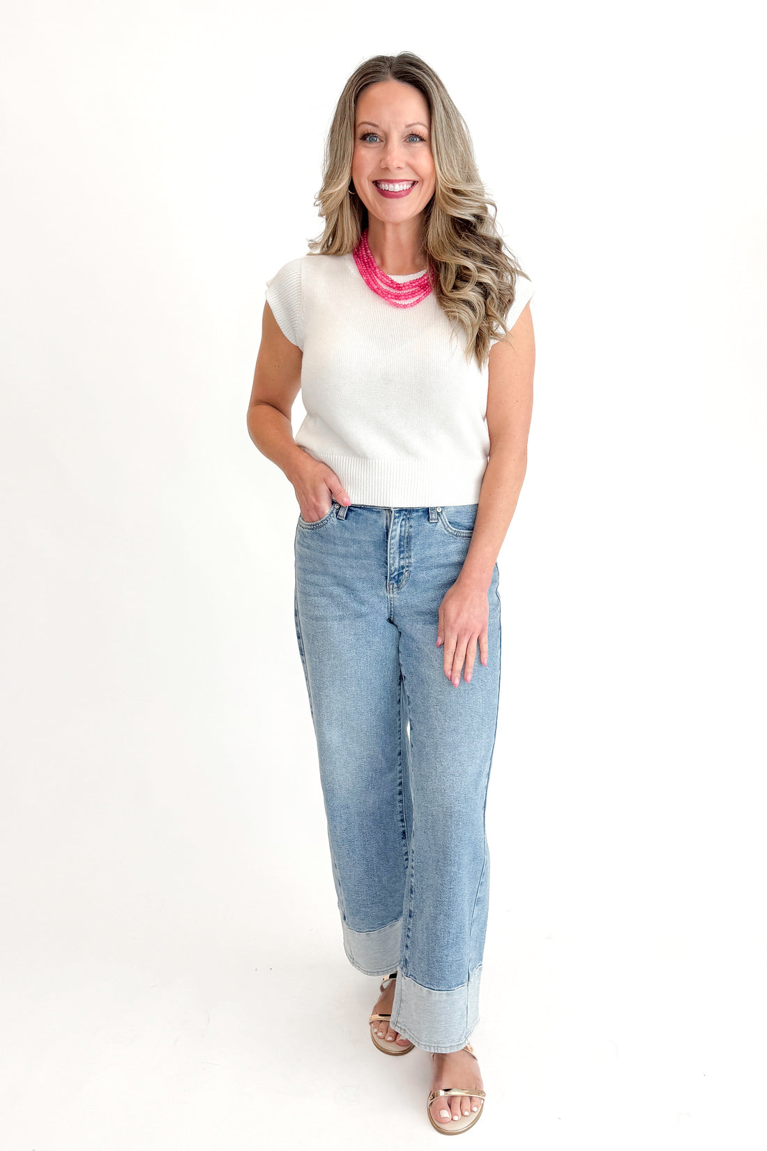 Front view of woman wearing Light Wash Two Toned Jeans by Just Black Denim with white sweater against white studio background.
