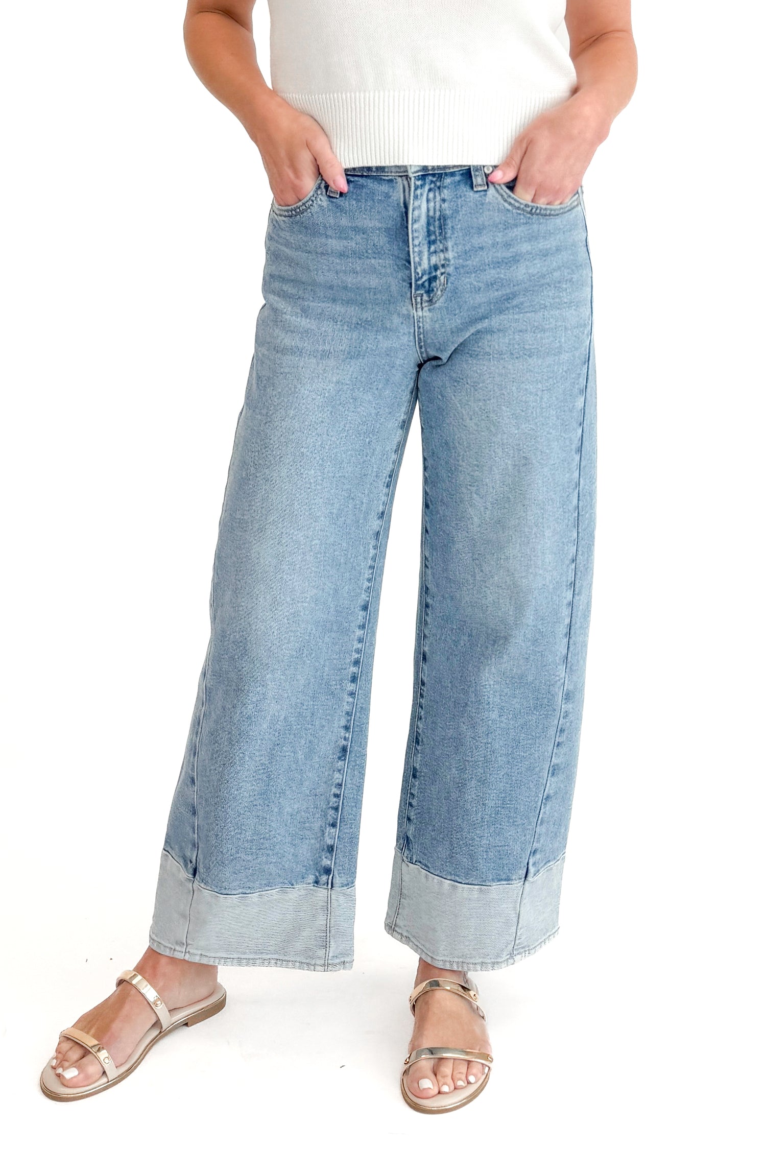 Front view of woman wearing Light Wash Two Toned Jeans by Just Black Denim with white sweater against white studio background.