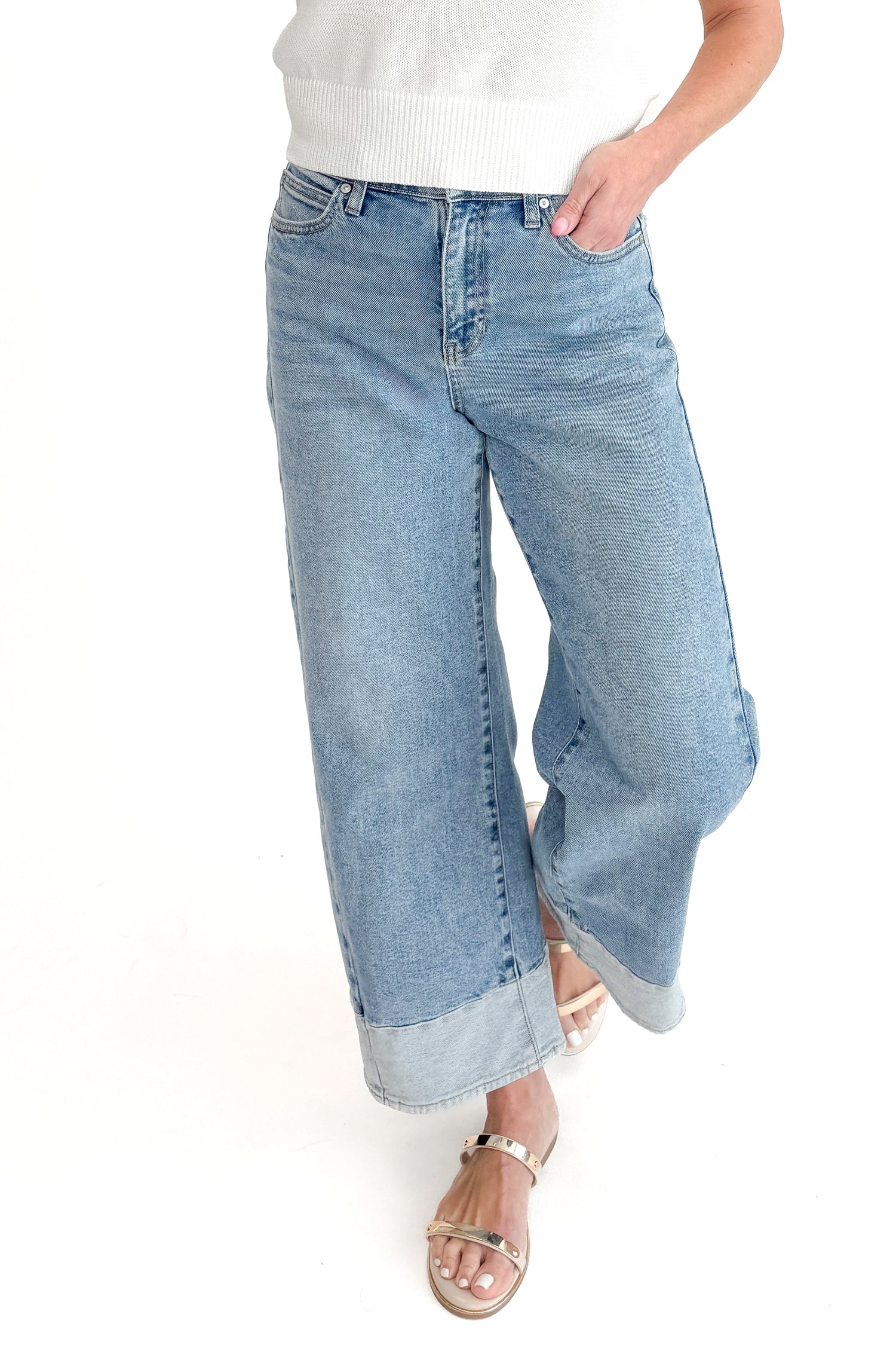 Front view of woman wearing Light Wash Two Toned Jeans by Just Black Denim with white sweater against white studio background.