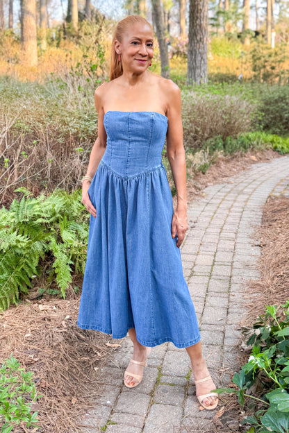 Front view of woman wearing Denim V-Waist Midi Dress with heels outside at a garden.