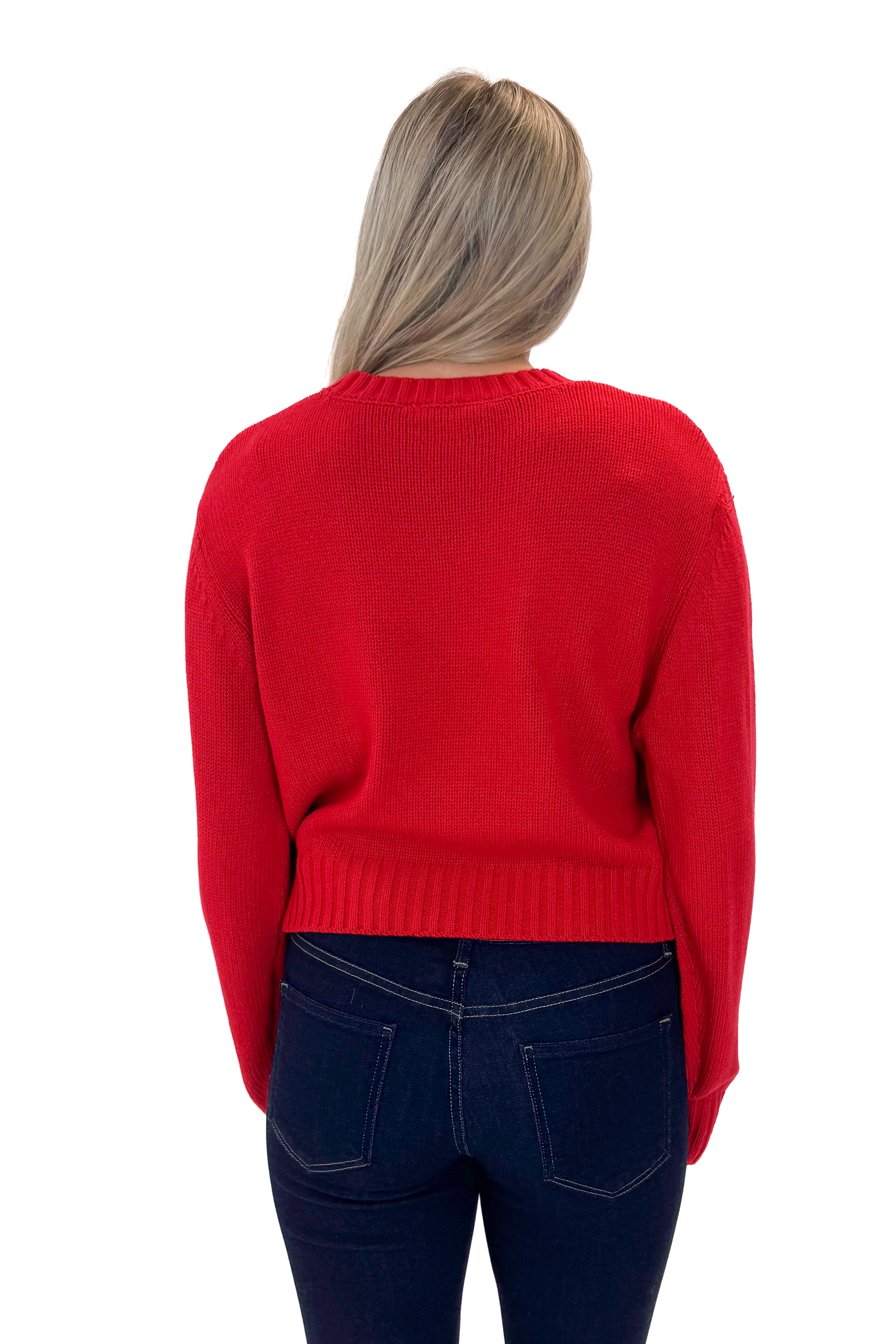 Back view of woman wearing Red Ribbed Neck Sweater with jeans against white studio background.