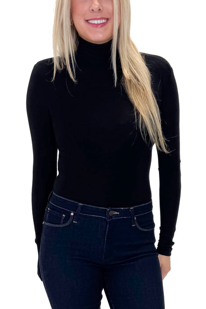 Front view of woman wearing Black Turtleneck Bodysuit with jeans against white studio background.