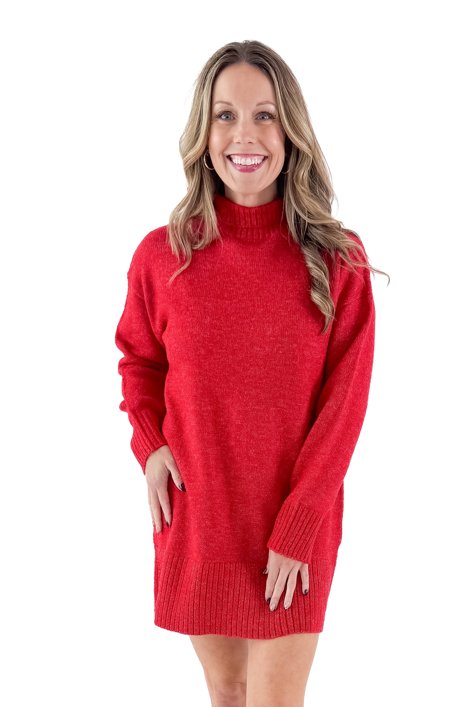 Front view of woman wearing red sweater dress with boots against white studio background.