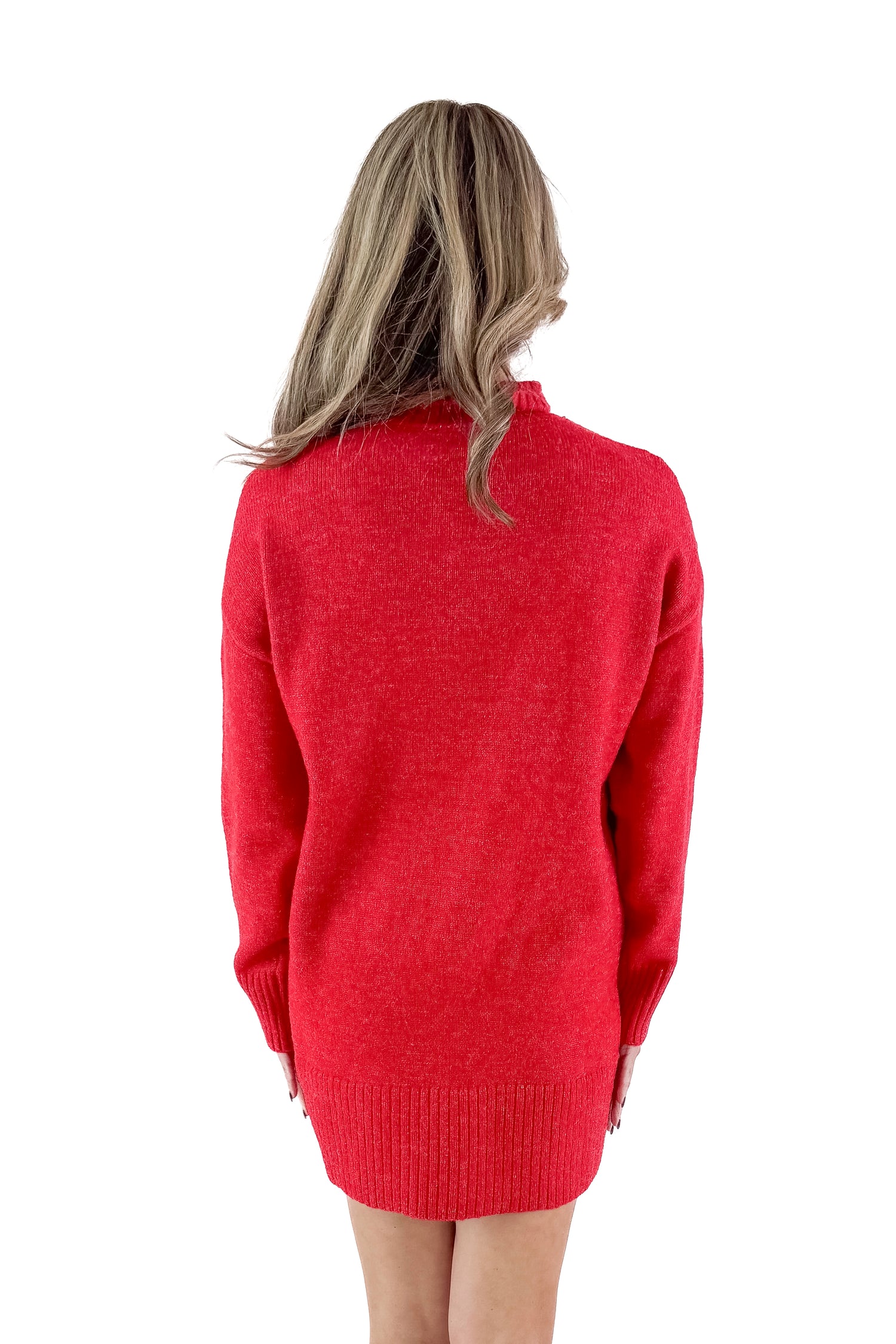 Back view of woman wearing red sweater dress against white studio background.
