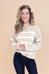 Studio picture of woman wearing Taupe and Cream Striped Mock Neck Sweater and jeans with tan background.