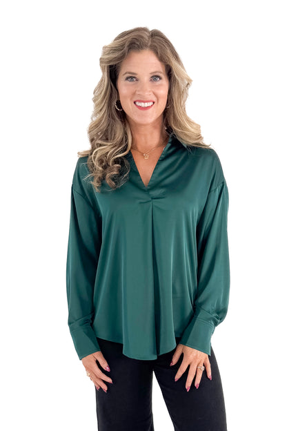 Front view of woman wearing Green Satin Collared V-neck Top with jeans against white studio background.