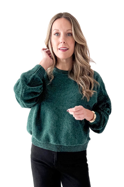 Front view of woman wearing Hunter Green Chenille Sweater with jeans against white studio background.