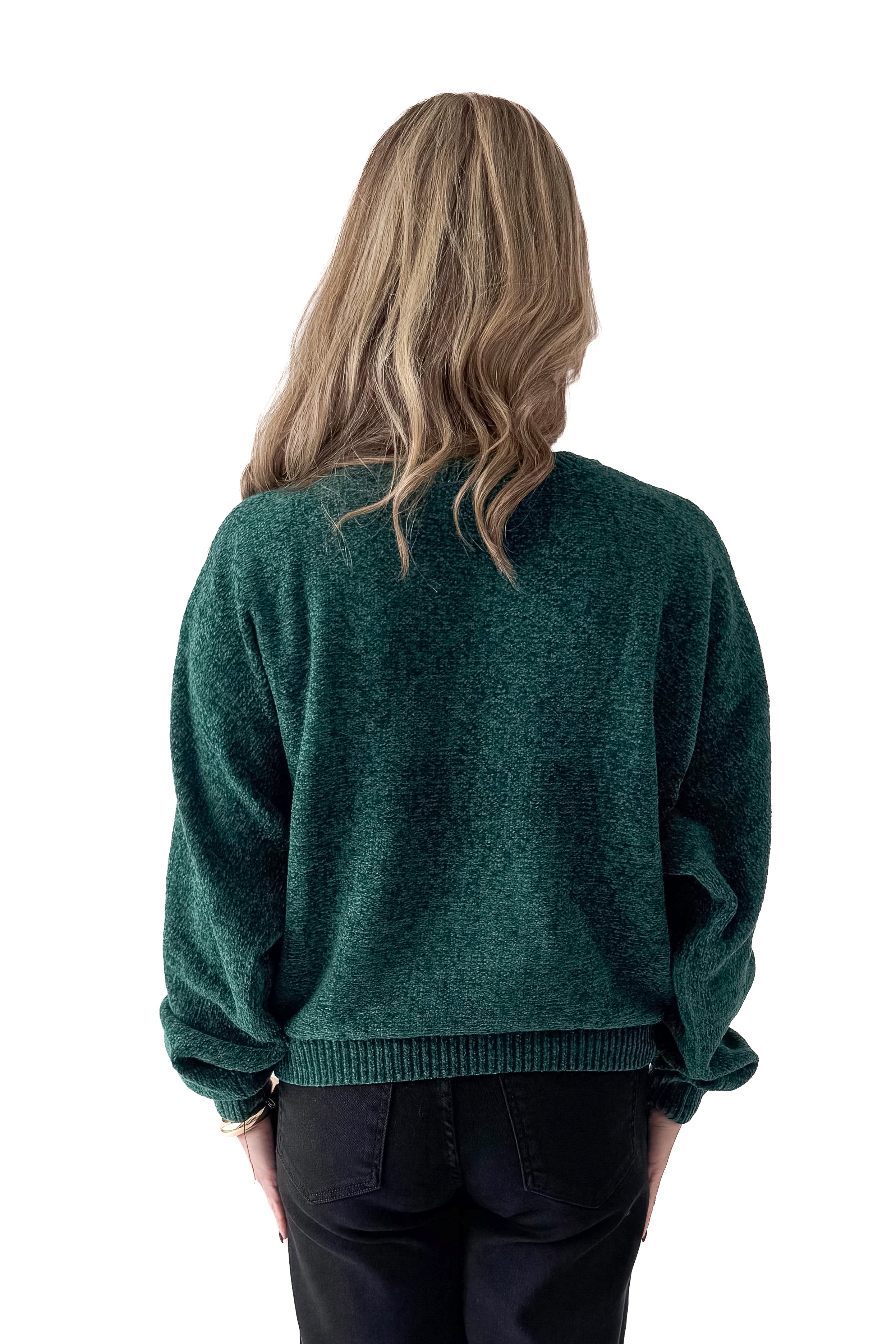 Back view of woman wearing Hunter Green Chenille Sweater with jeans against white studio background.