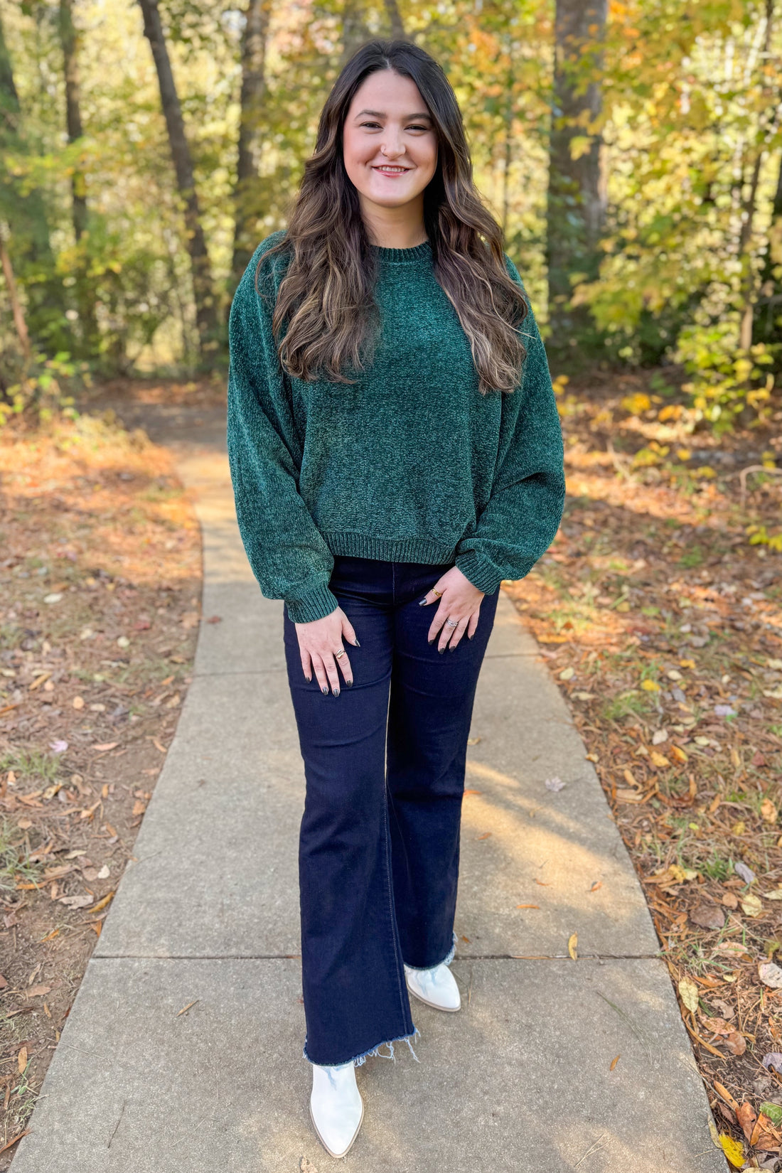 Front view of woman wearing Hunter Green Chenille Sweater with jeans outside.