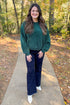 Front view of woman wearing Hunter Green Chenille Sweater with jeans outside.