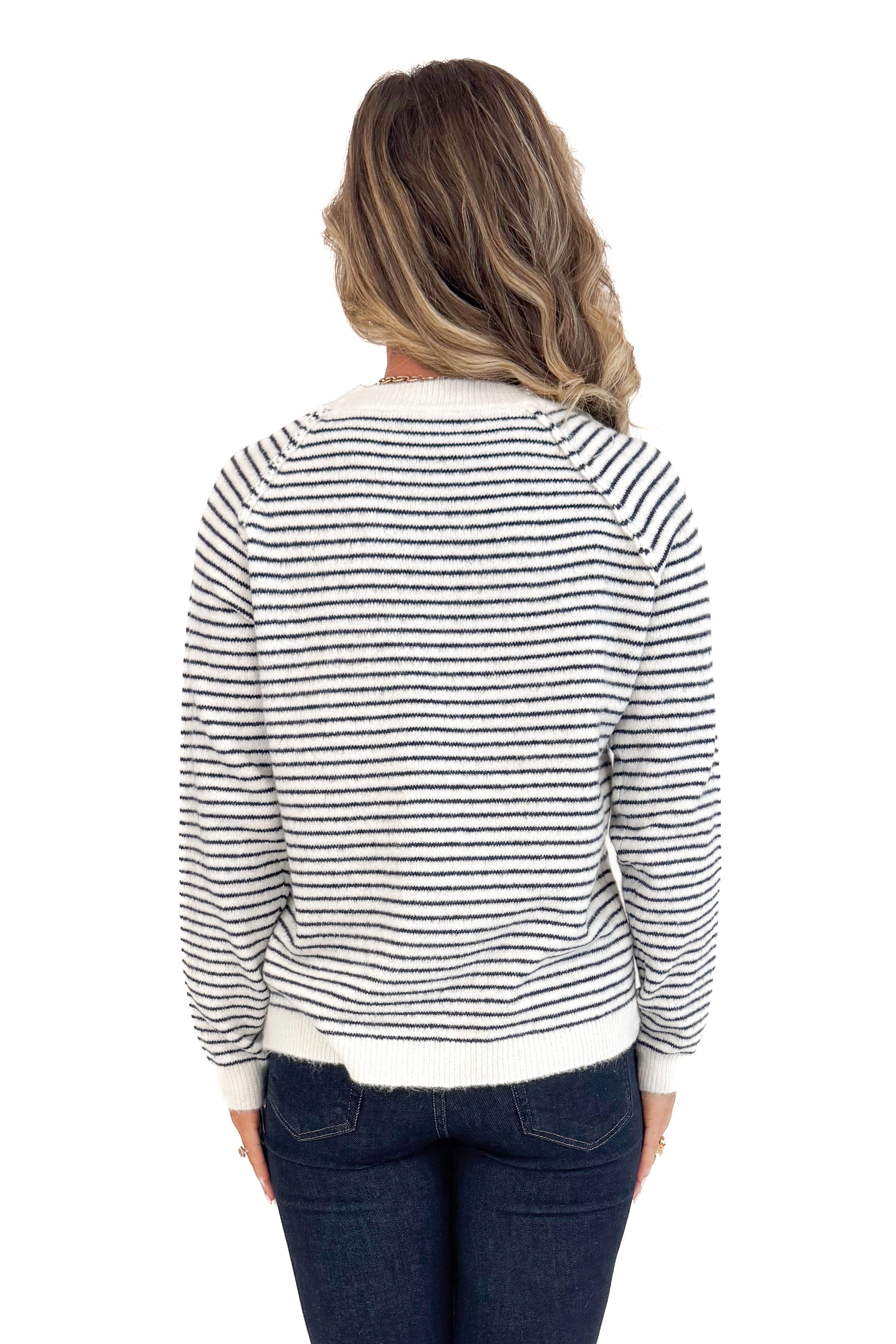 Back view of woman wearing Cream &amp; Black Striped Long Sleeve Top and blue jeans. 
