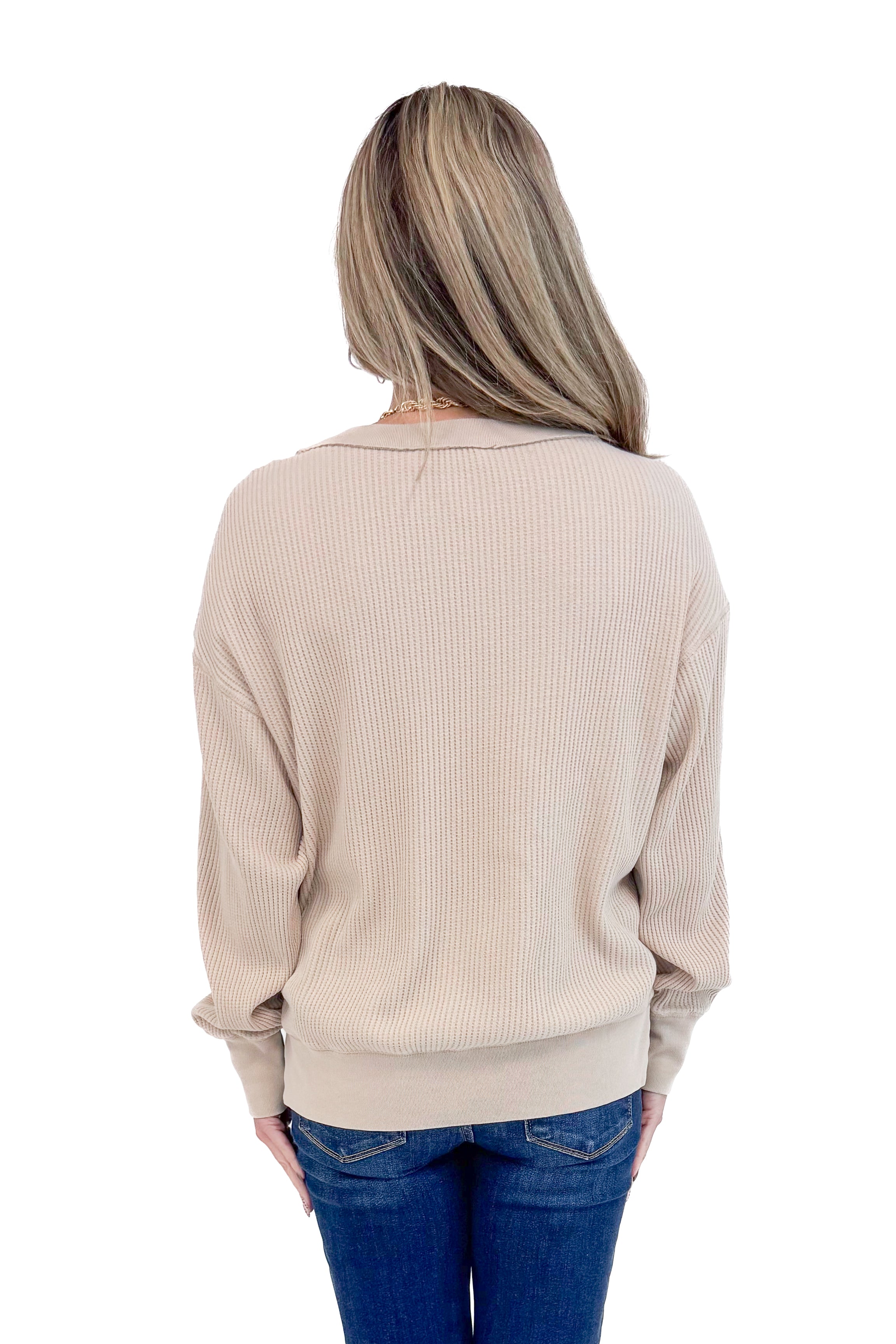 Back view of woman wearing Washed Taupe Round Neck Waffle Weave Top and blue jeans against a white background.