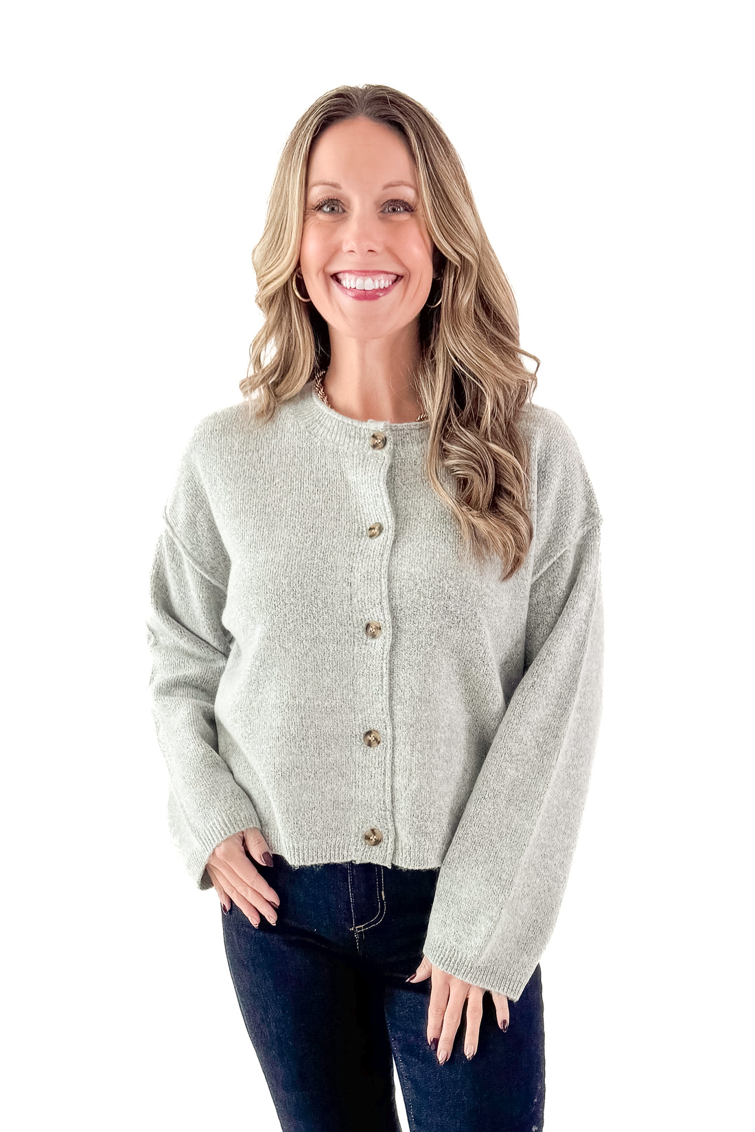 Front view of woman wearing Heather Grey Button Up Cardigan with jeans against white studio background.