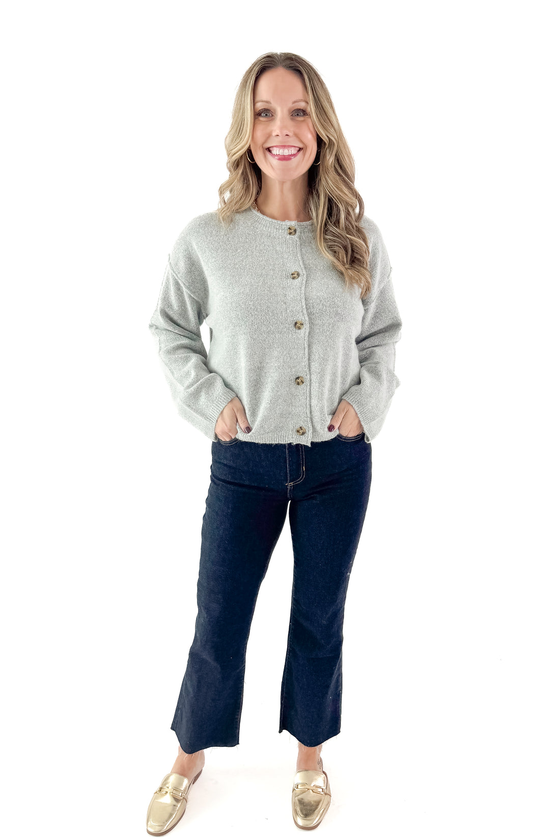 Front view of woman wearing Heather Grey Button Up Cardigan with jeans against white studio background.