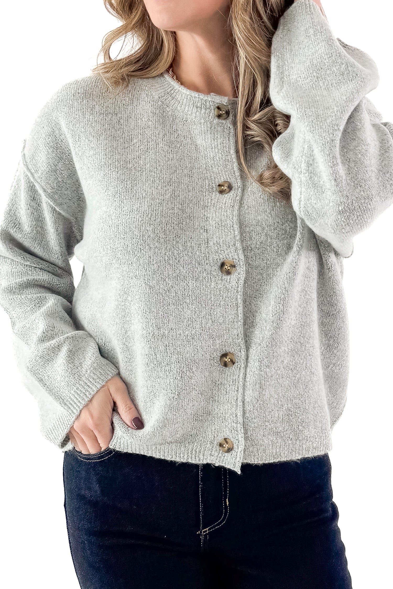 Front detailed view of woman wearing Heather Grey Button Up Cardigan with jeans against white studio background.